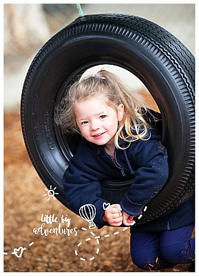 A girl swings on a tyre swing at her kindergarten.  Photo by Little Big Adventures