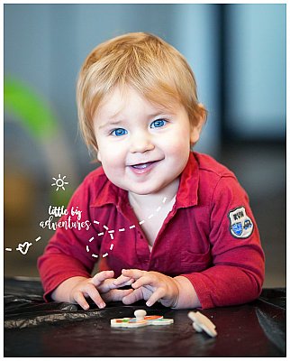 A young boy of 2yrs does a jigsaw puzzle at his childcare.  Photo by Little Big Adventures