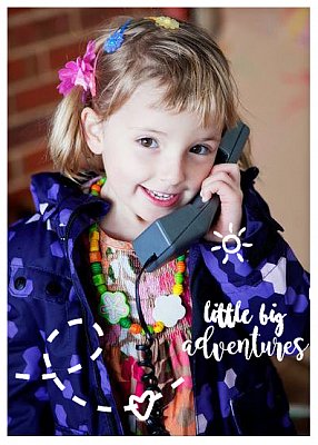 kindergarten girl on the telephone at kindergarten, posing for the camera
